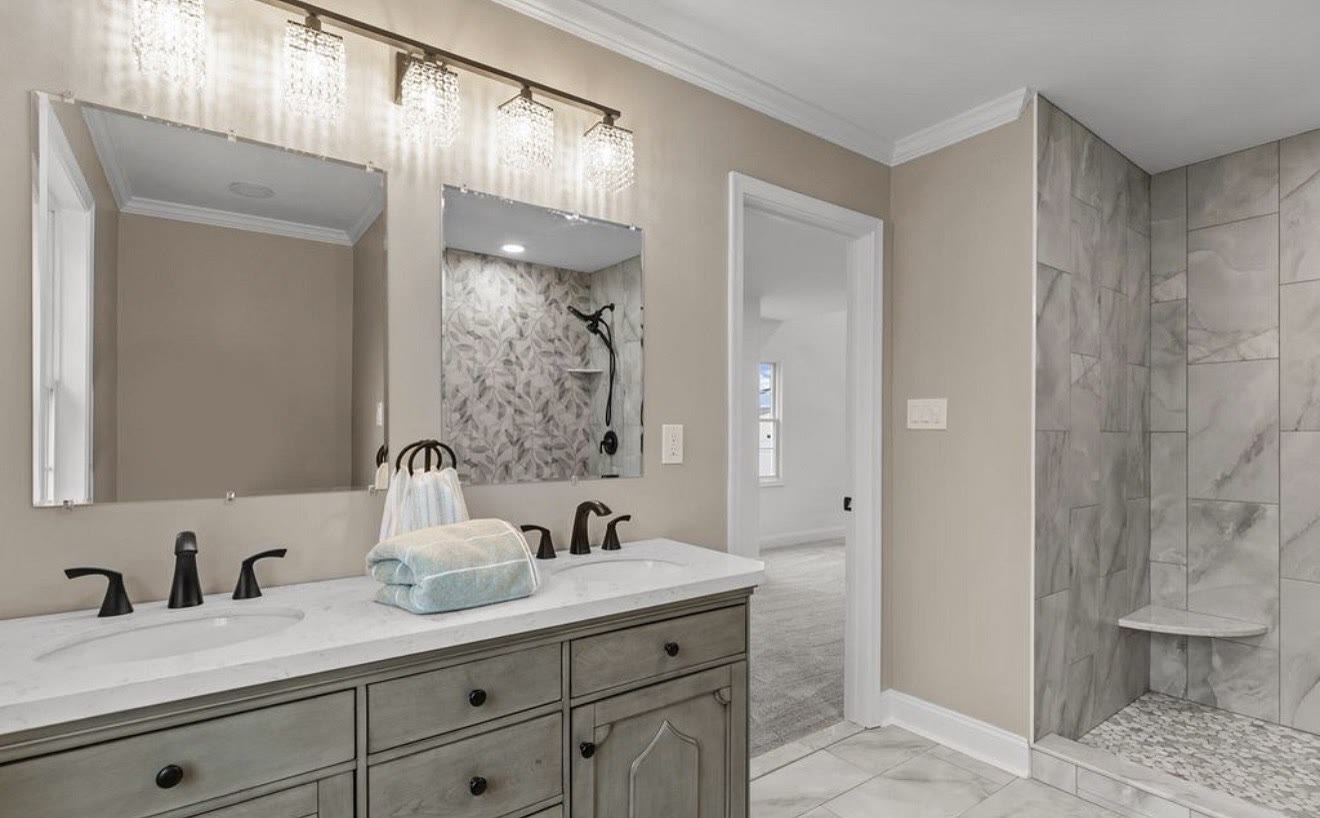 Master bathroom with double vanity and walk-in tile shower